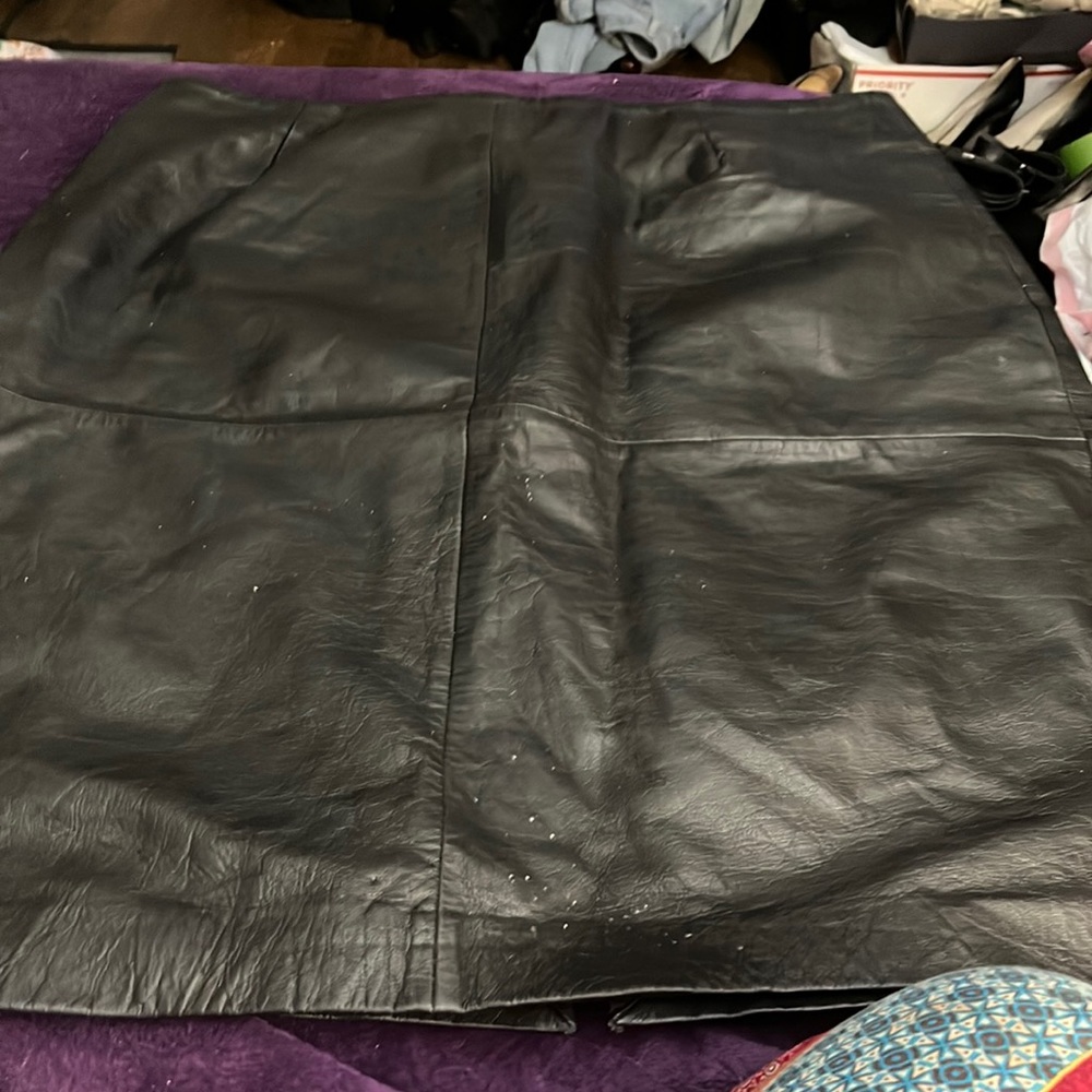 Black real leather skirt and a matching vest for him .